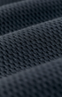 Close-up of a dark charcoal gray knit fabric texture with a fine mesh-like weave.