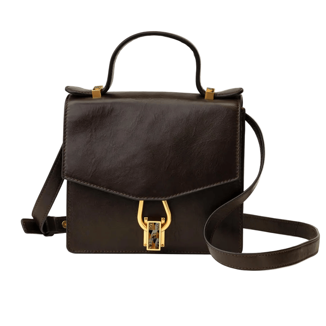 Black leather handbag with gold accents on a white background