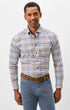 A man wearing a long-sleeve button-down shirt with a multicolor plaid pattern in blue, orange, and white, paired with blue jeans and a brown belt, against a plain light gray background.