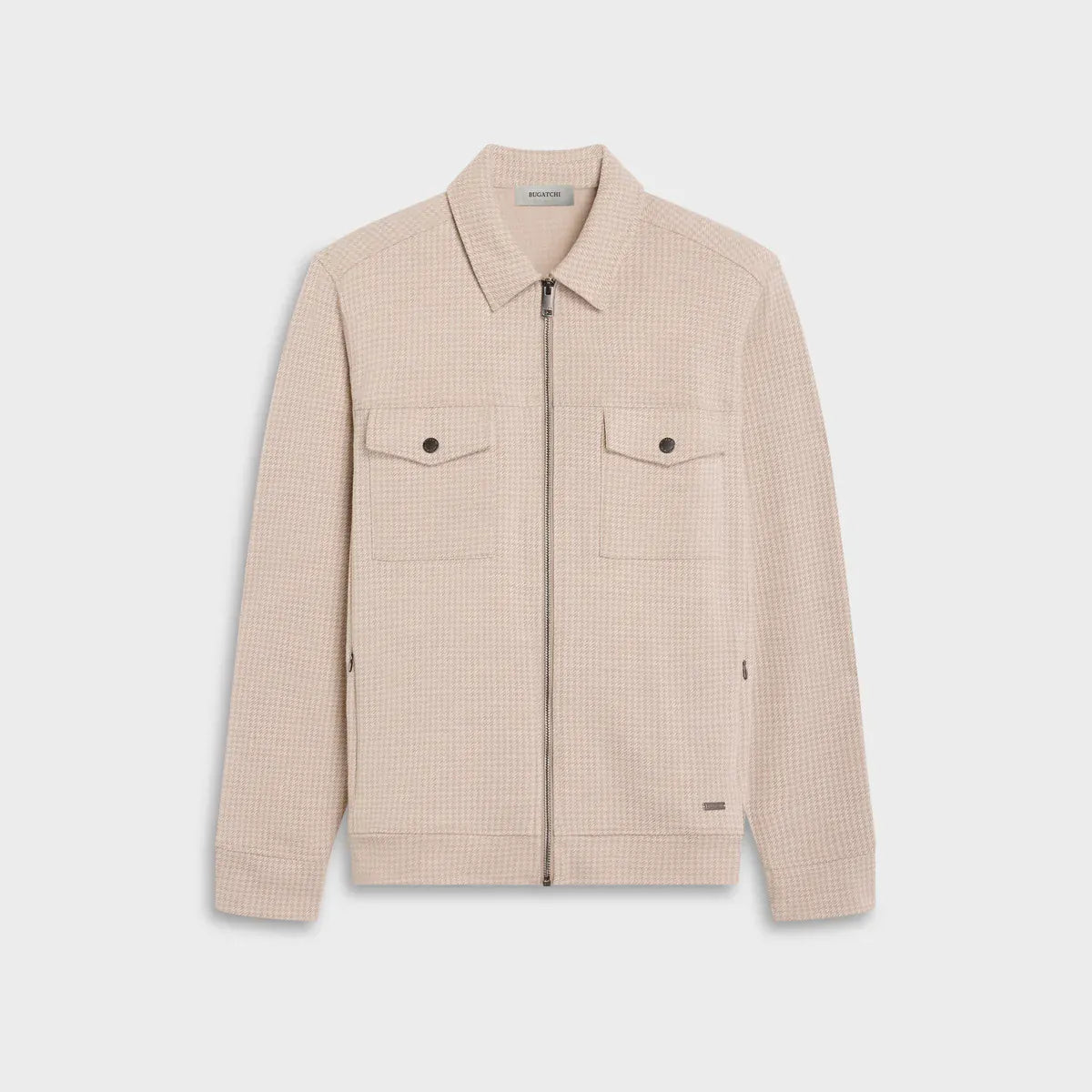 A light beige textured zip-up jacket with a pointed collar, two buttoned chest flap pockets, and zippered hand pockets, shown flat on a light gray background.