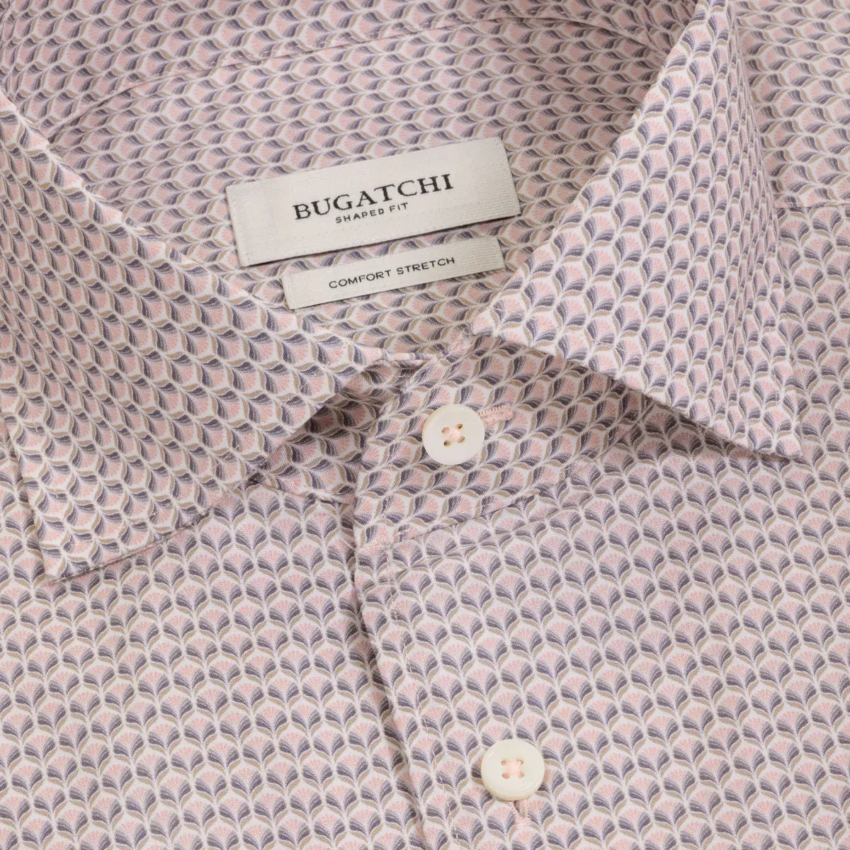 Close-up of a Bugatchi men's dress shirt with a fine repeating geometric pattern in dusty pink, beige, and gray, featuring a white collar label and white buttons.