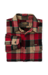 A folded Filson plaid flannel shirt in red, beige, and green, displayed on a clean white background.